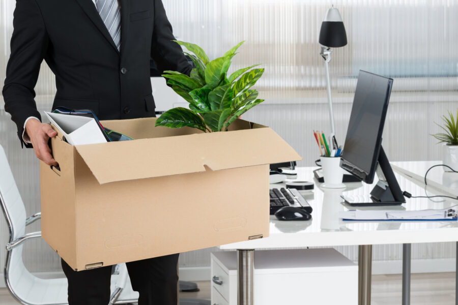 Midsection of Businessman Carrying Cardboard Box by Used Office Furniture in Boca Raton, Weston, Broward, and Palm Beach